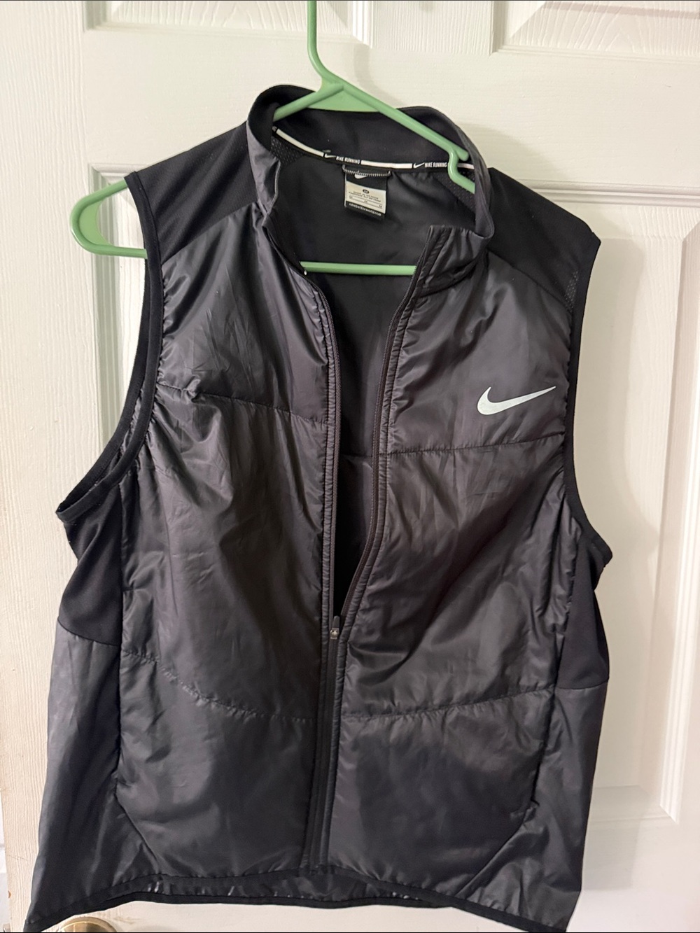 Nike woman’s Black Sleeveless Puffer Vest with White Swoosh
